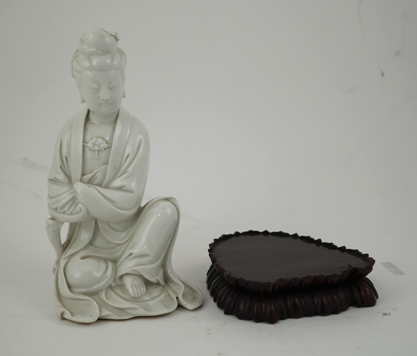 A Chinese blanc-de-chine seated figure of Guanyin, late 19th/early 20th century